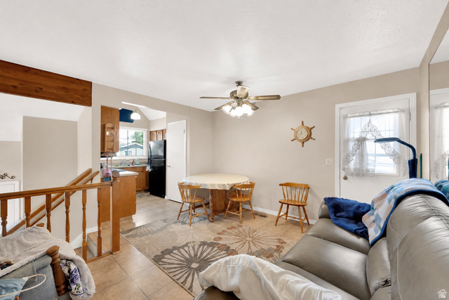 8029 Angel Street Sandy, UT 84070 - Photo 6 of 21 Open-concept living space featuring a ceiling fan, light-toned walls, and a tiled flooring surface