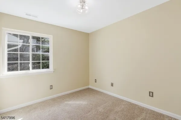 a bedroom with a bed and a night stand