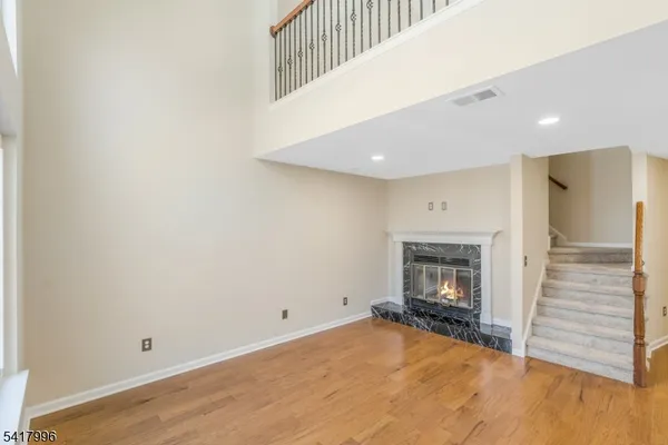 a view of empty room with a fireplace