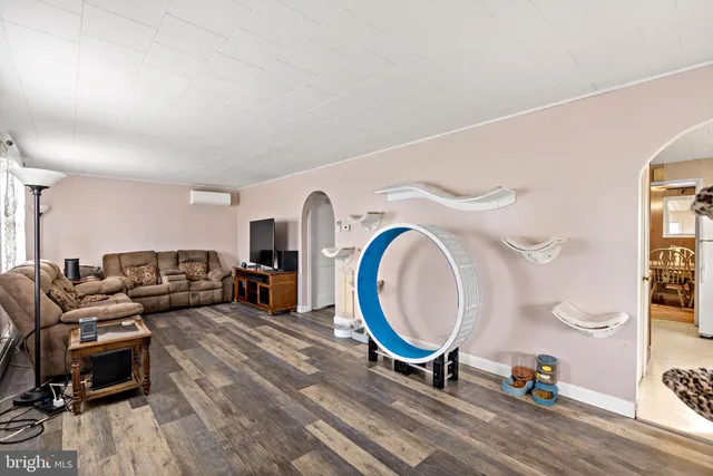 a living room with furniture a clock and a table