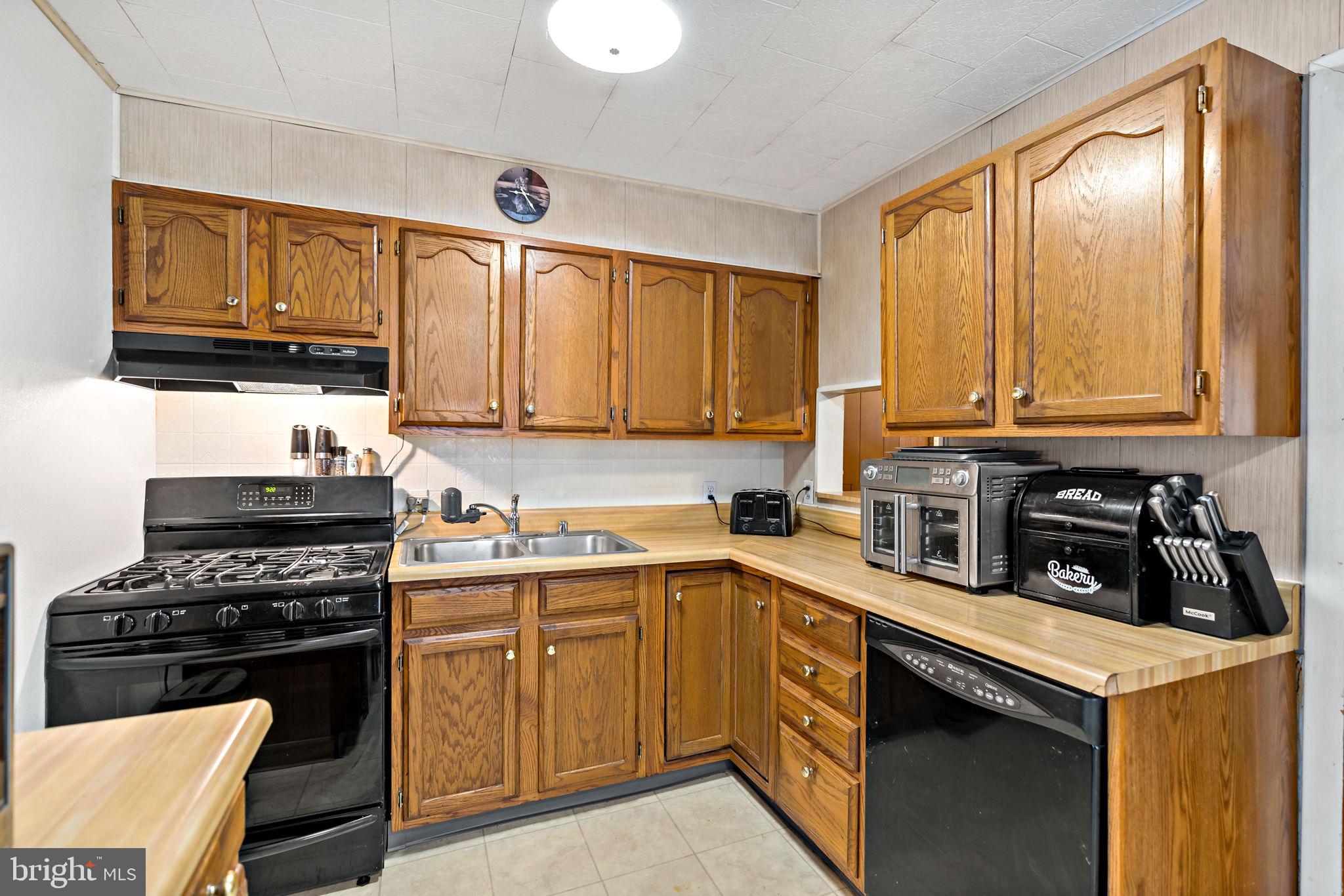 3421 Cornwall Road Dundalk, MD 21222 - Photo 20 of 45 a kitchen with a sink stove top oven and cabinets