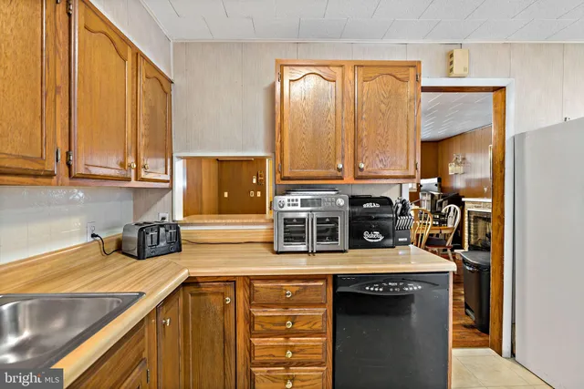 a kitchen with stainless steel appliances a sink a stove and cabinets