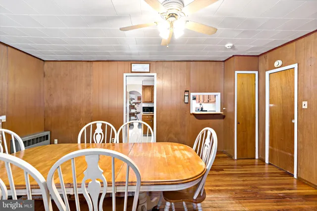 a front view of a dining room with furniture window and wooden floor