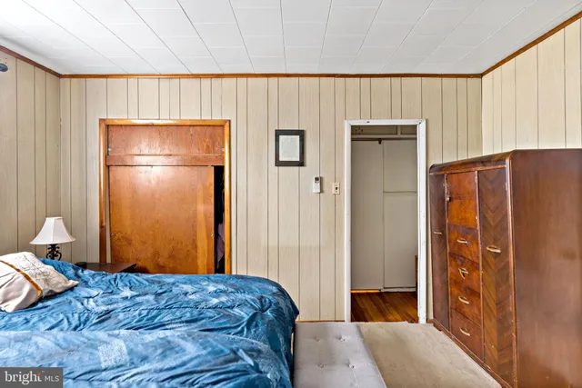 a bedroom with a bed and flat screen tv