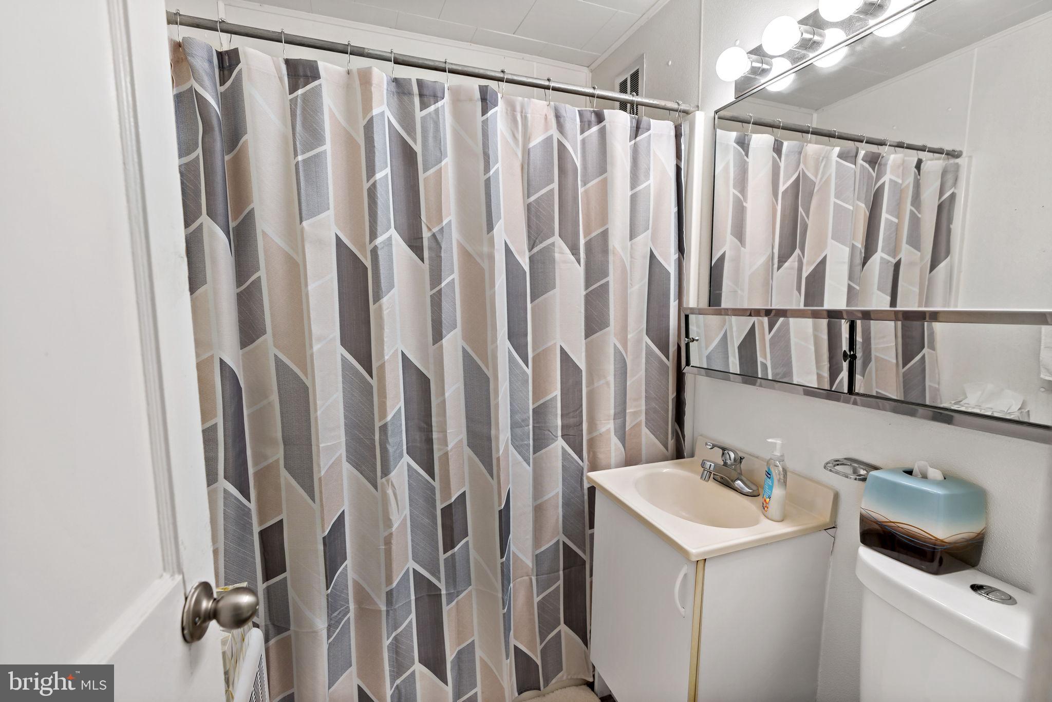 3421 Cornwall Road Dundalk, MD 21222 - Photo 35 of 45 a bathroom with a sink and a mirror