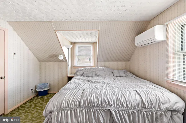 a bedroom with a bed and a dresser