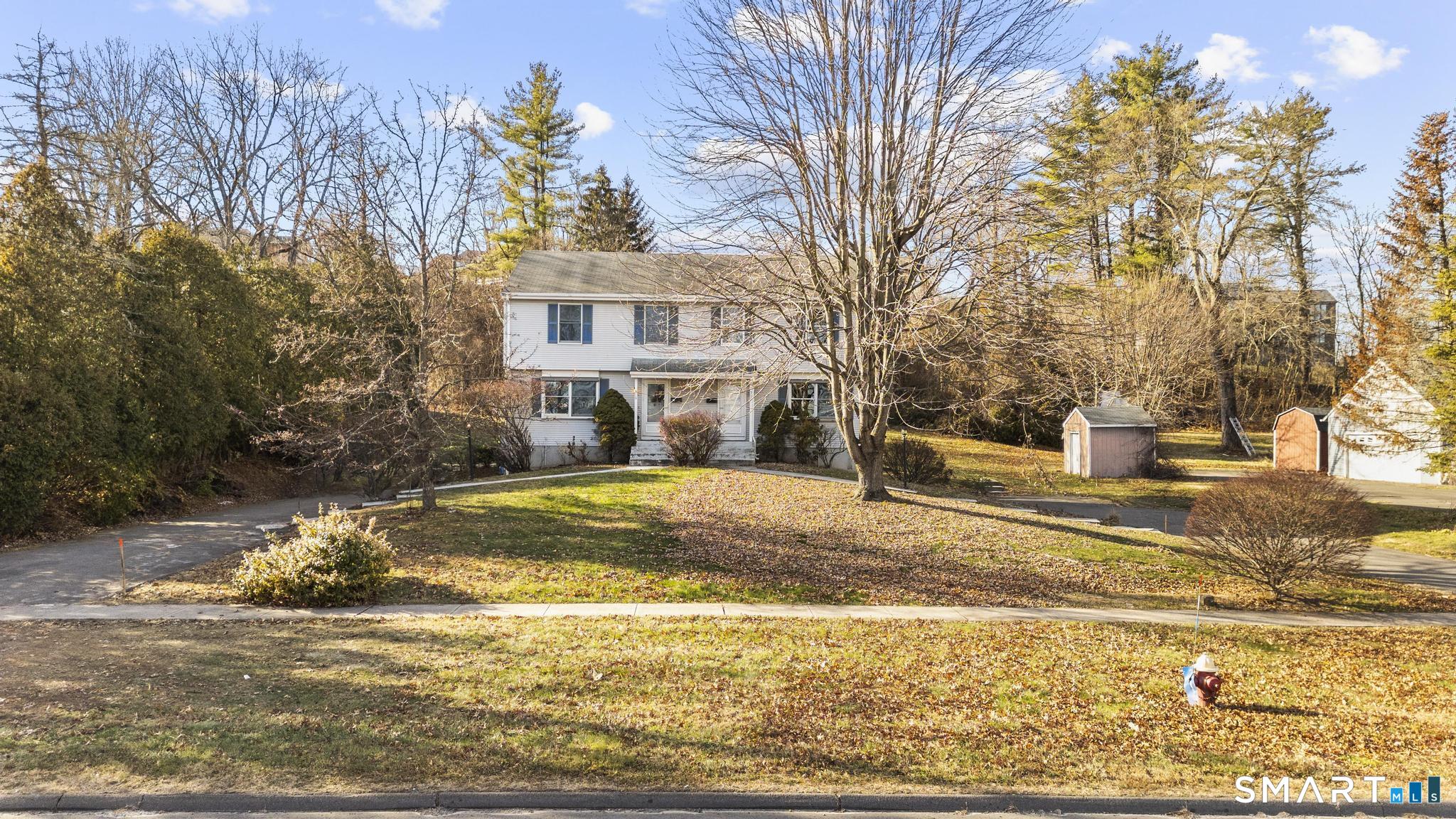 a view of a house with snow on the road