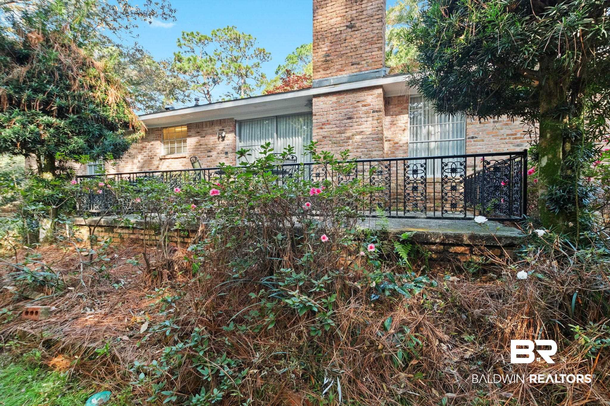 752 Evergreen Street Fairhope, AL 36532 - Photo 63 of 100 View of home's exterior featuring brick siding and a chimney
