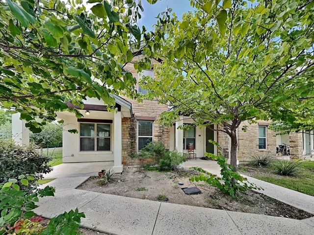 front view of a house with a tree