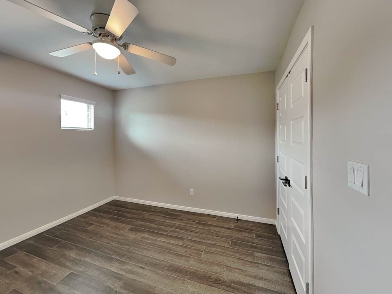 179 Holly Street, Unit 201 Georgetown, TX 78626 - Photo 12 of 17 wooden floor in an empty room with a window