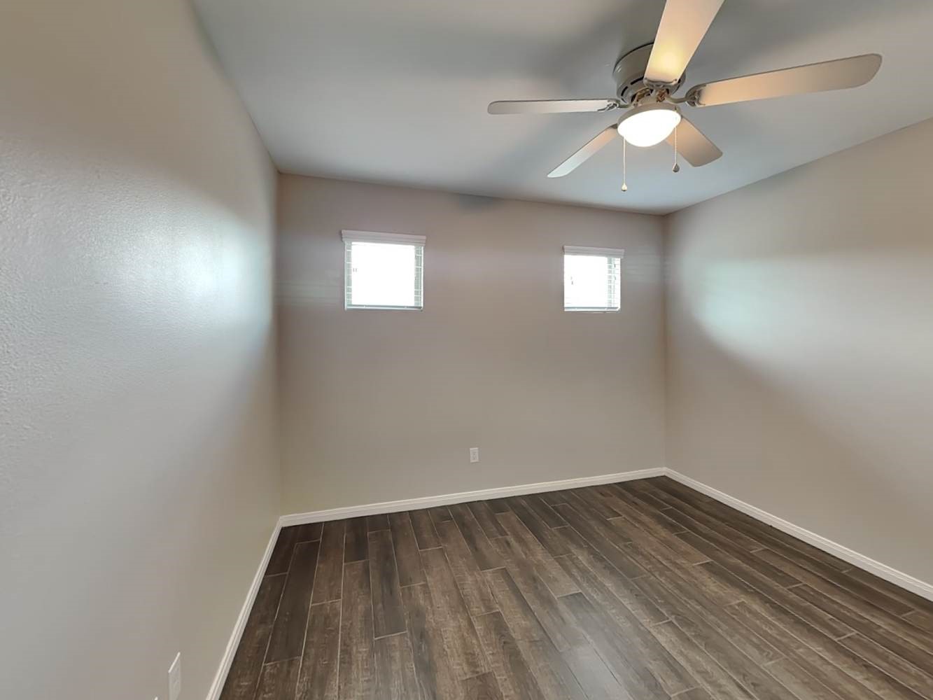 179 Holly Street, Unit 201 Georgetown, TX 78626 - Photo 13 of 17 an empty room with wooden floor and windows