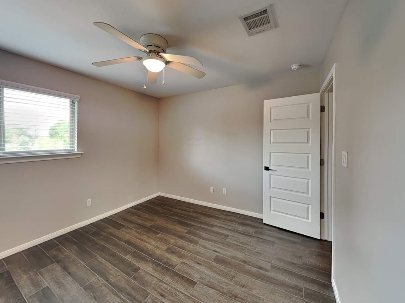 179 Holly Street, Unit 201 Georgetown, TX 78626 - Photo 14 of 17 an empty room with wooden floor cabinet and windows