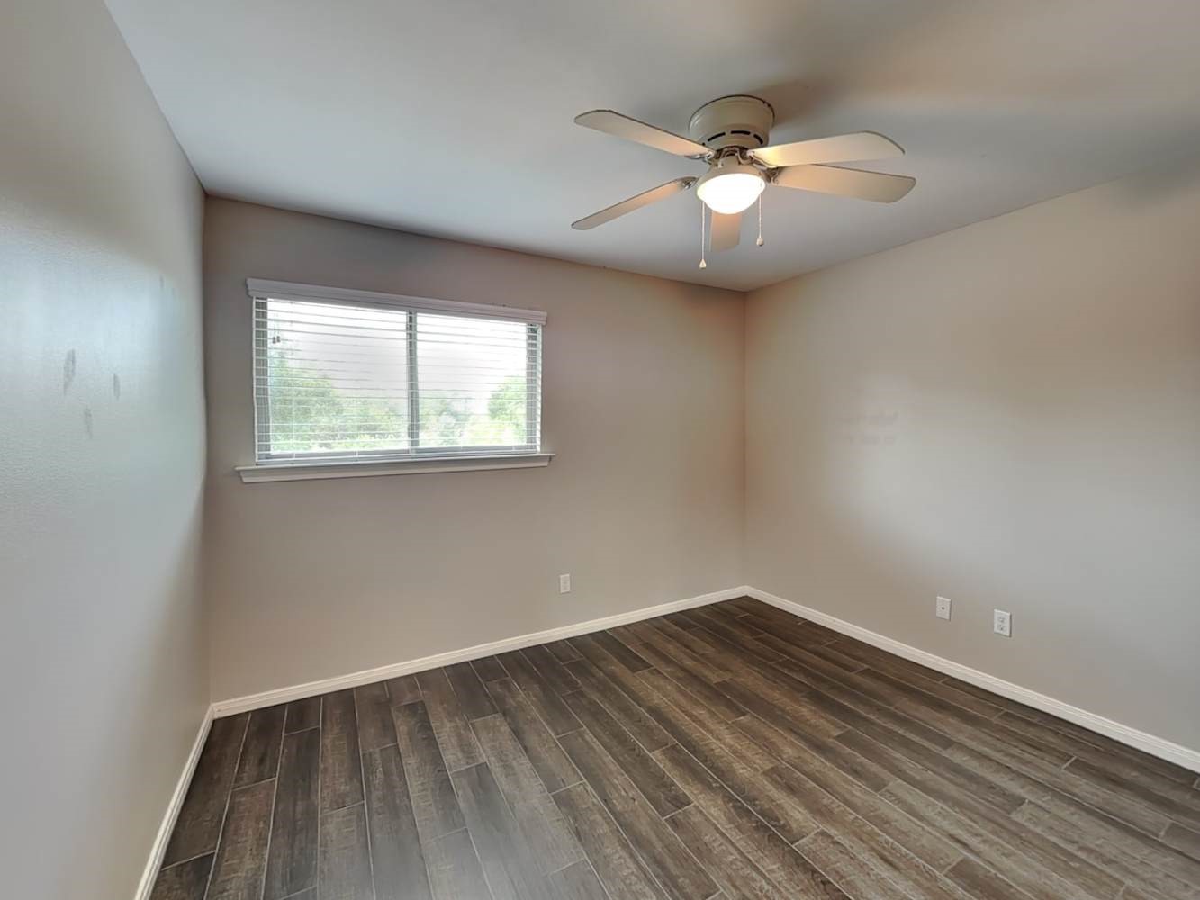 179 Holly Street, Unit 201 Georgetown, TX 78626 - Photo 15 of 17 an empty room with wooden floor and windows