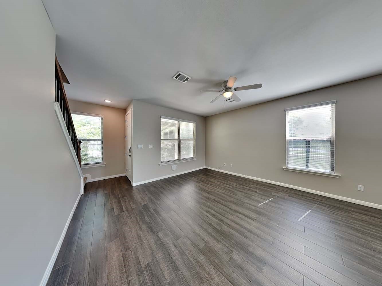 179 Holly Street, Unit 201 Georgetown, TX 78626 - Photo 2 of 17 an empty room with wooden floor and windows
