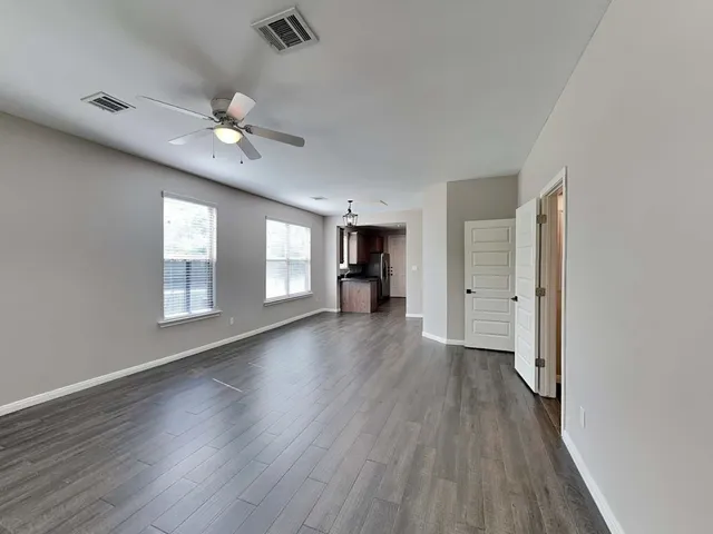 wooden floor in an empty room with a window
