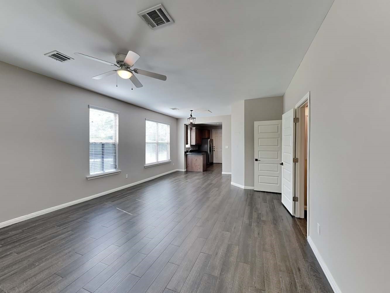 179 Holly Street, Unit 201 Georgetown, TX 78626 - Photo 3 of 17 wooden floor in an empty room with a window