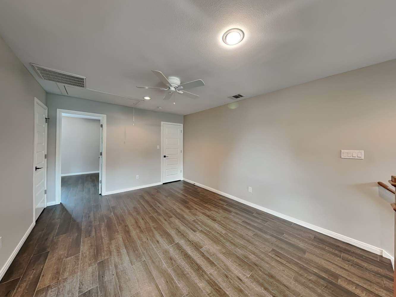 179 Holly Street, Unit 201 Georgetown, TX 78626 - Photo 5 of 17 a view of an empty room with wooden floor and a window