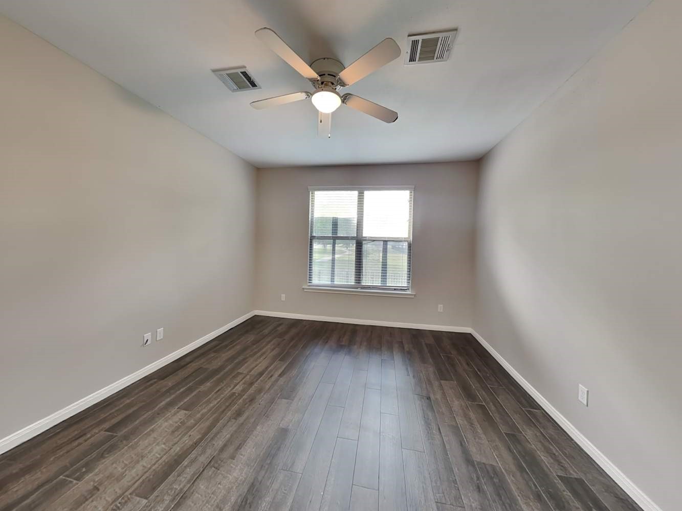179 Holly Street, Unit 201 Georgetown, TX 78626 - Photo 10 of 17 an empty room with wooden floor and windows