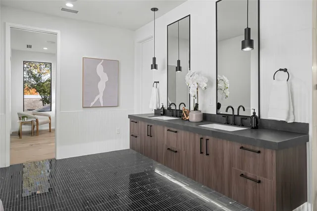 a large white room with a large window and stainless steel appliances