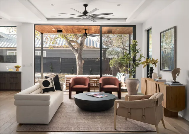 a living room with furniture and a floor to ceiling window