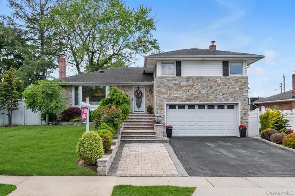 a front view of a house with a garden