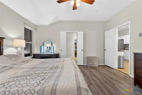 a bedroom with a bed and wooden floor