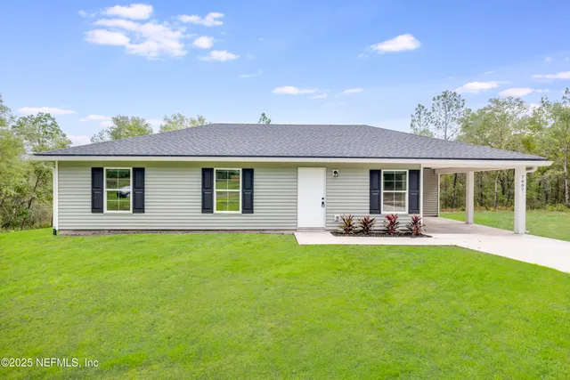 a front view of a house with patio and yard