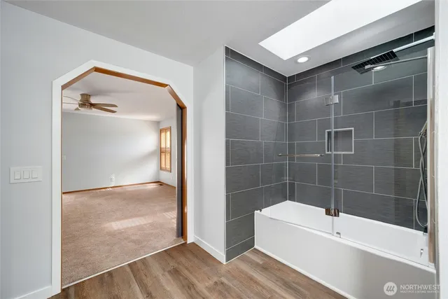 a bathroom with a bathtub and a shower