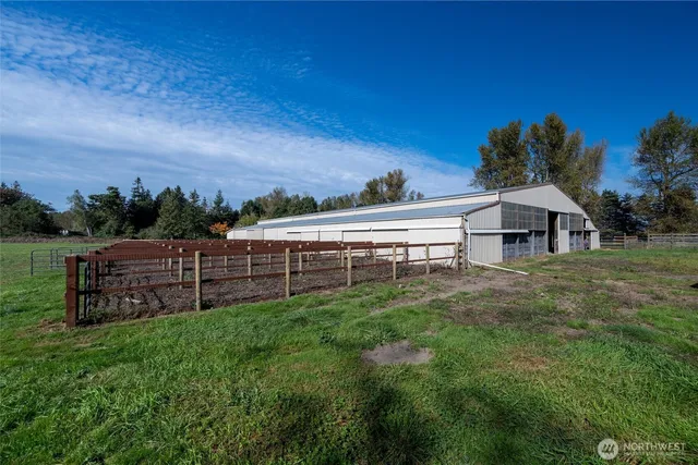 a view of a house with a yard and sitting area