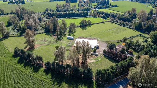 an aerial view of residential houses with outdoor space and swimming pool