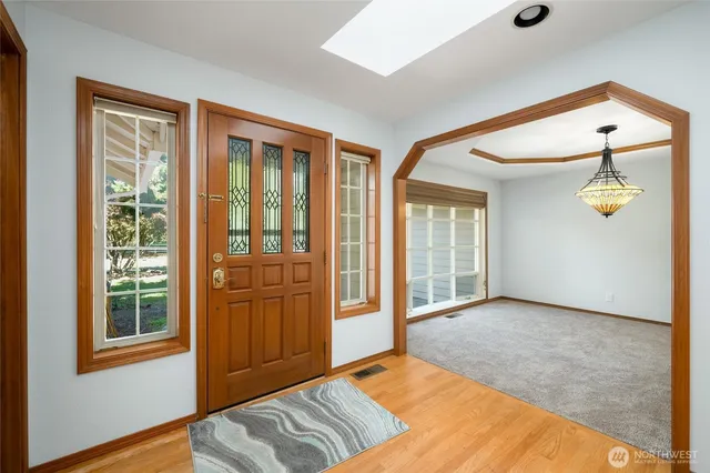 an empty room with windows and cabinet