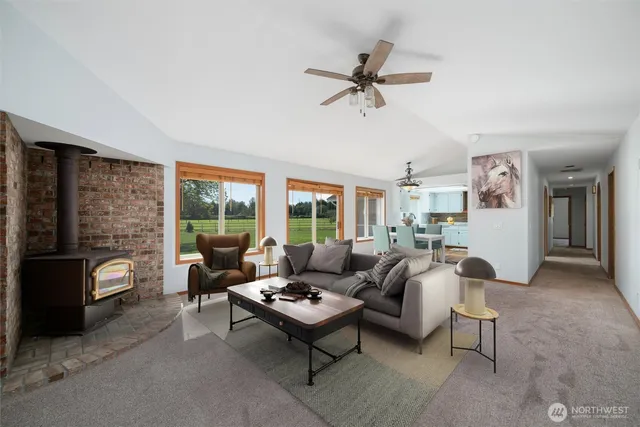a living room with furniture and a floor to ceiling window