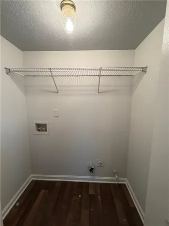 a view of empty room with fireplace and wooden floor