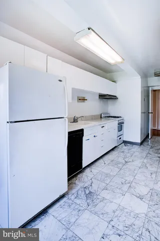 a kitchen with appliances cabinets and a window