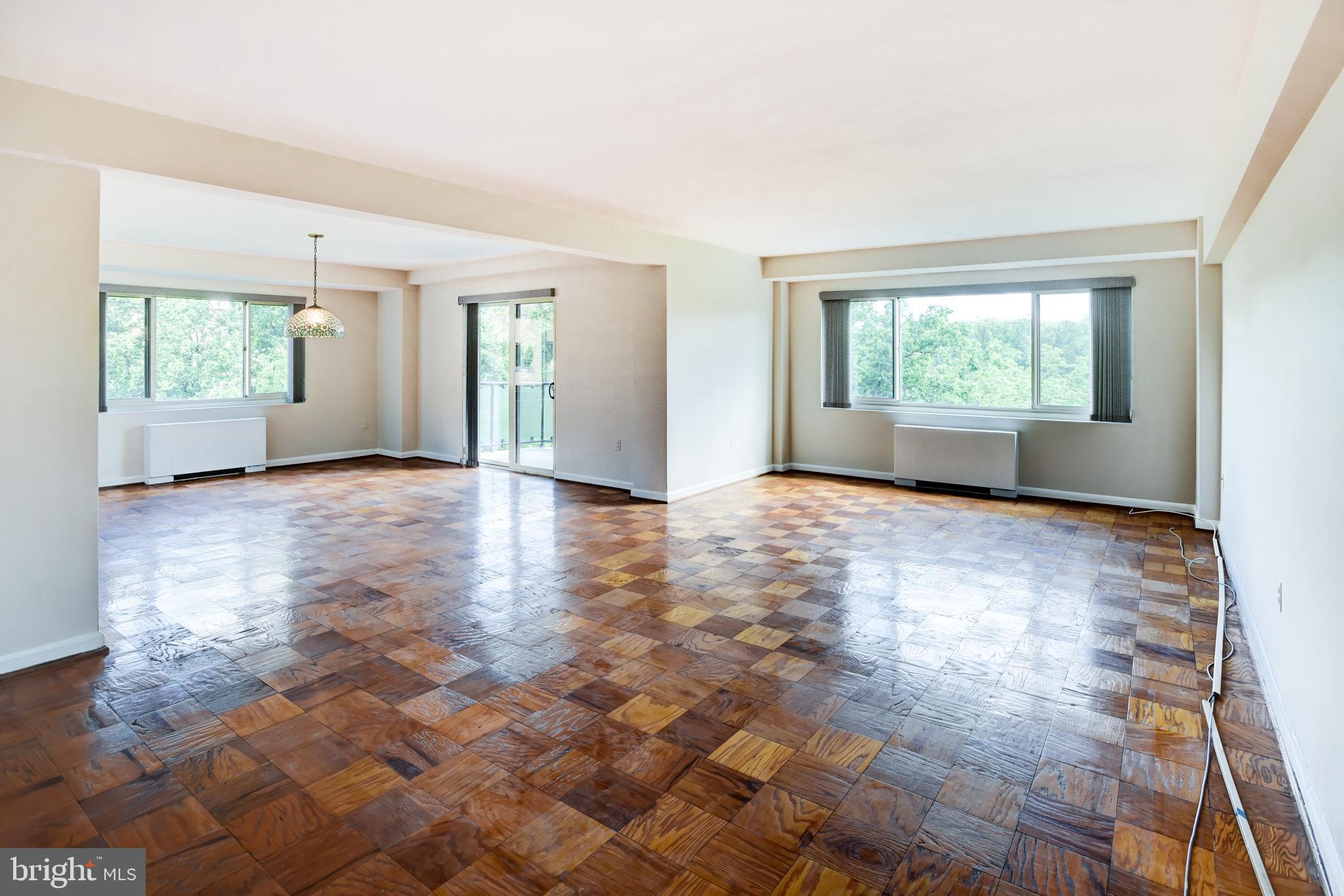4201 Cathedral Avenue Northwest, Unit 1004E Washington, DC 20016 - Photo 9 of 69 a view of empty room with wooden floor and fan