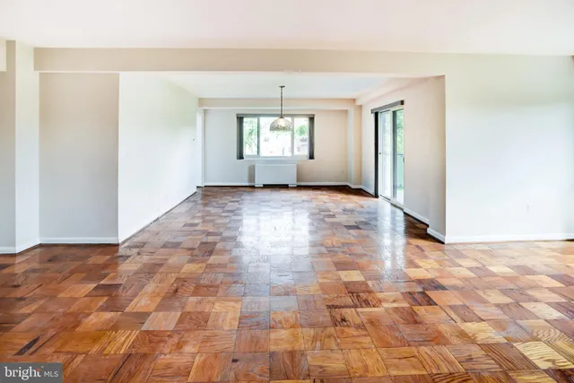 a view of empty room with wooden floor