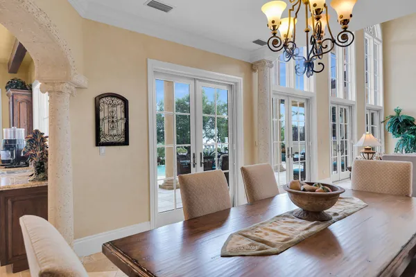 a view of a patio with couches table and chairs and potted plants