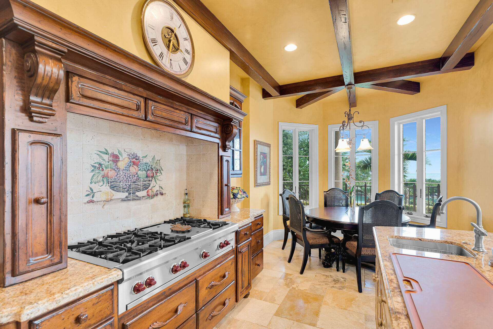 301 Ixora Street Marathon, FL 33050 - Photo 17 of 91 a kitchen with stainless steel appliances a stove a table and chairs with wooden floor