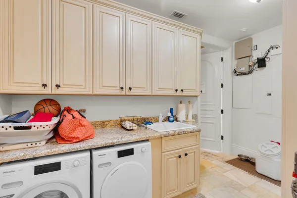 a living room with furniture or chandelier and a wooden floor