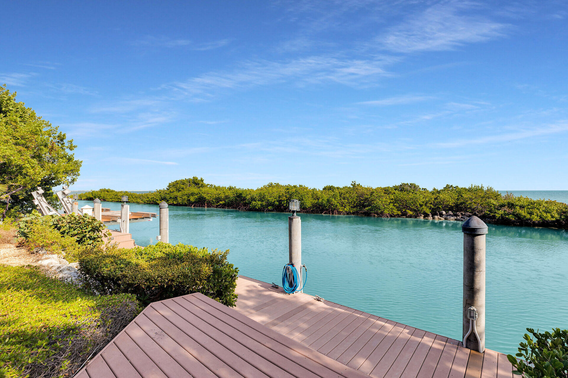 301 Ixora Street Marathon, FL 33050 - Photo 77 of 91 a view of a lake with a house in the background