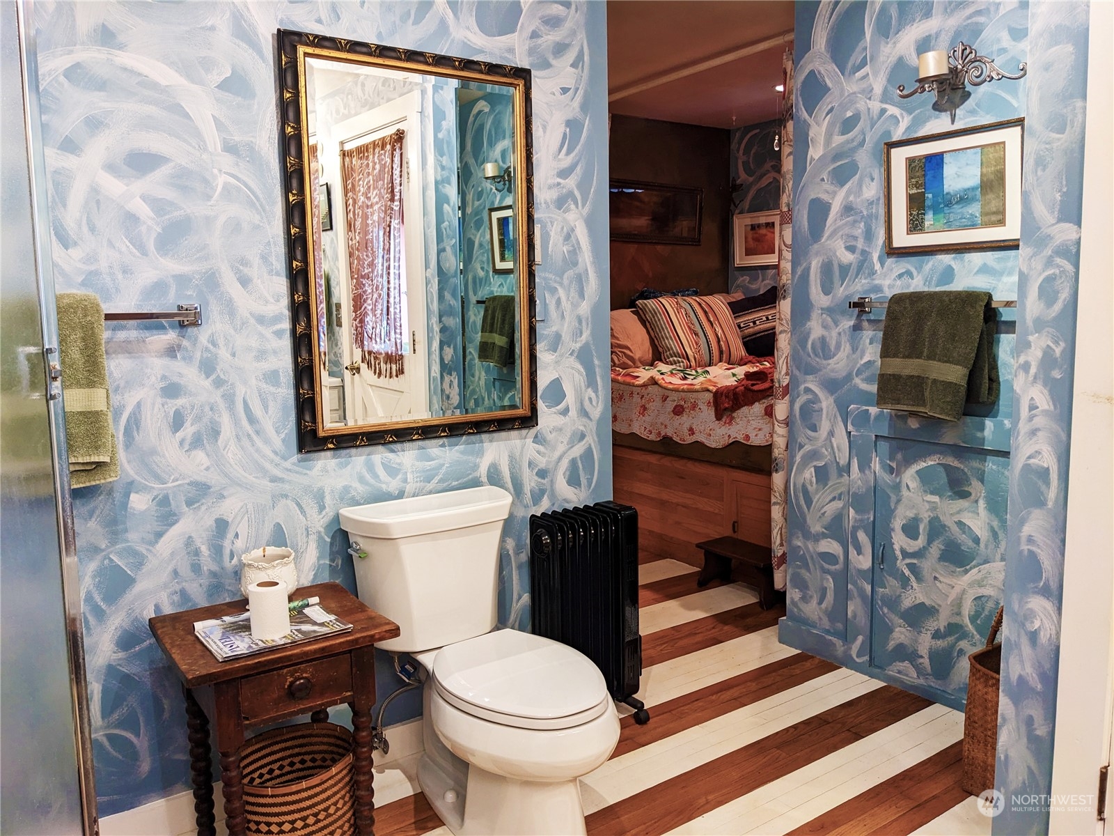 175 Dabob Post Office Road Quilcene, WA 98376 - Photo 13 of 40 a bathroom with a toilet a sink and a shower curtain