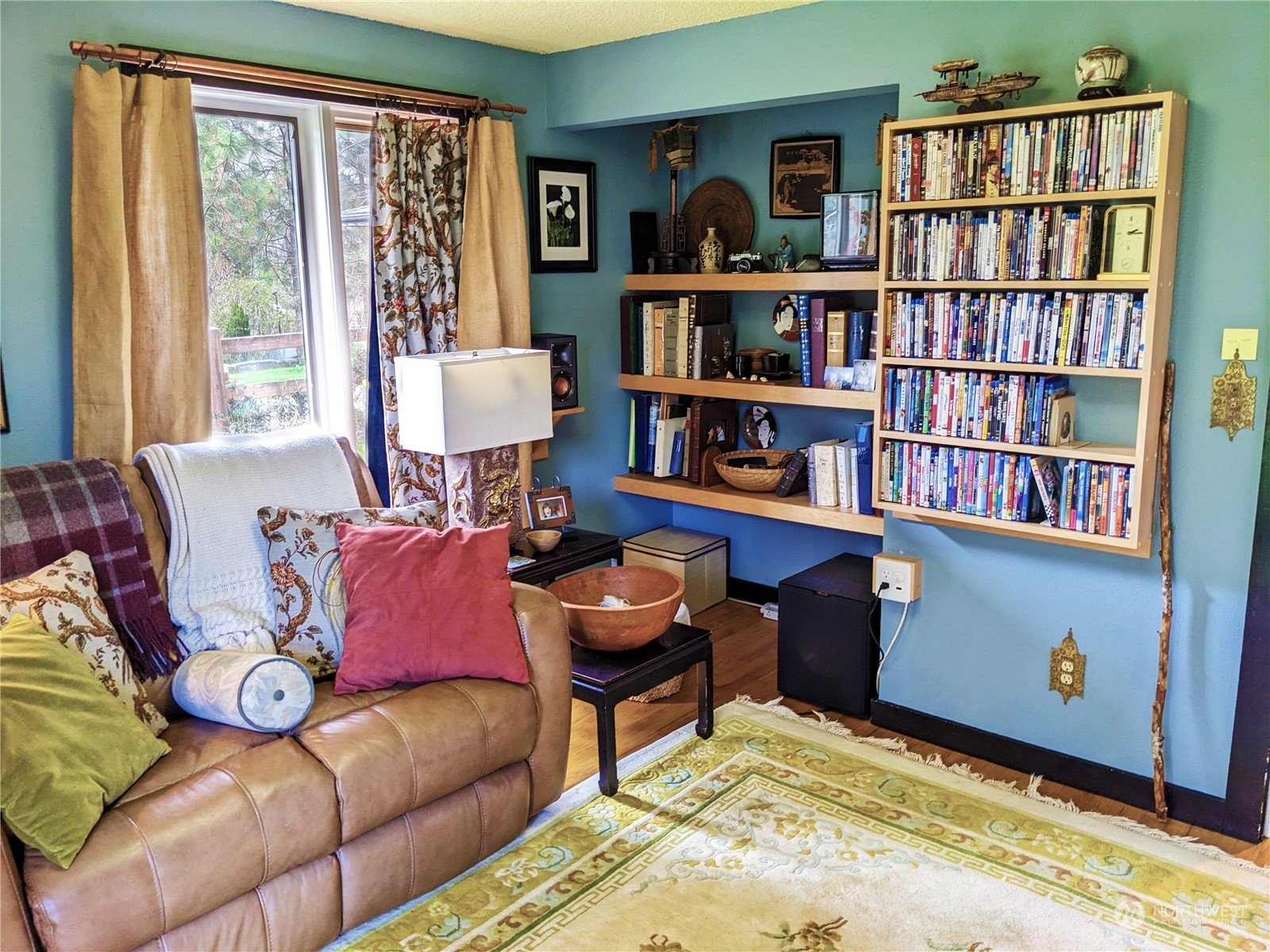 175 Dabob Post Office Road Quilcene, WA 98376 - Photo 15 of 40 a living room with furniture and a book shelf