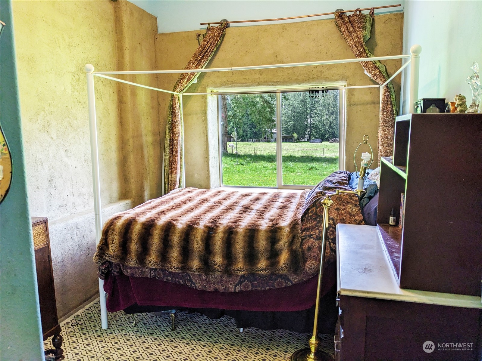 175 Dabob Post Office Road Quilcene, WA 98376 - Photo 22 of 40 a bed sitting in a bedroom next to a yard