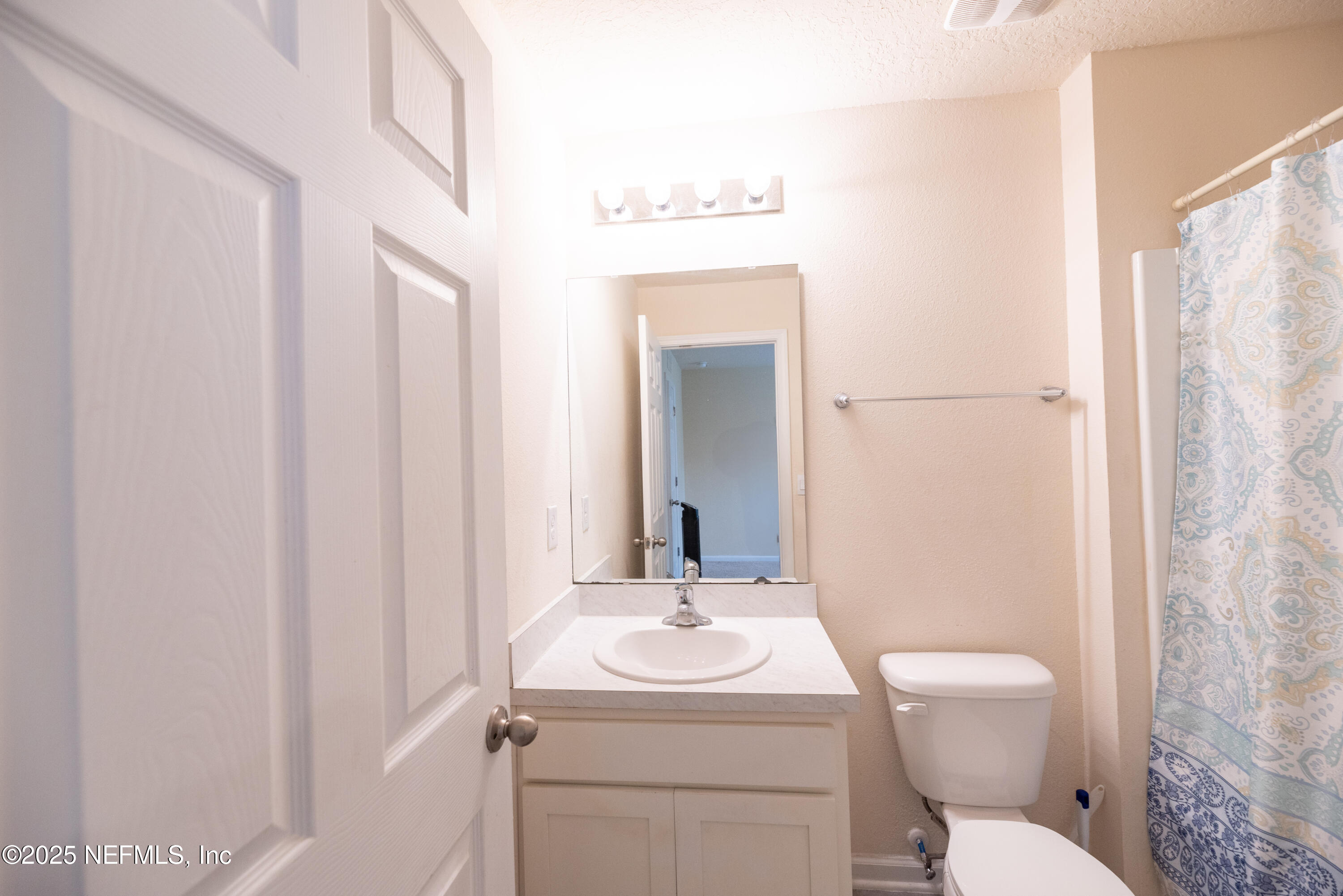 86990 Mainline Road Yulee, FL 32097 - Photo 11 of 17 a bathroom with a toilet a sink and a mirror