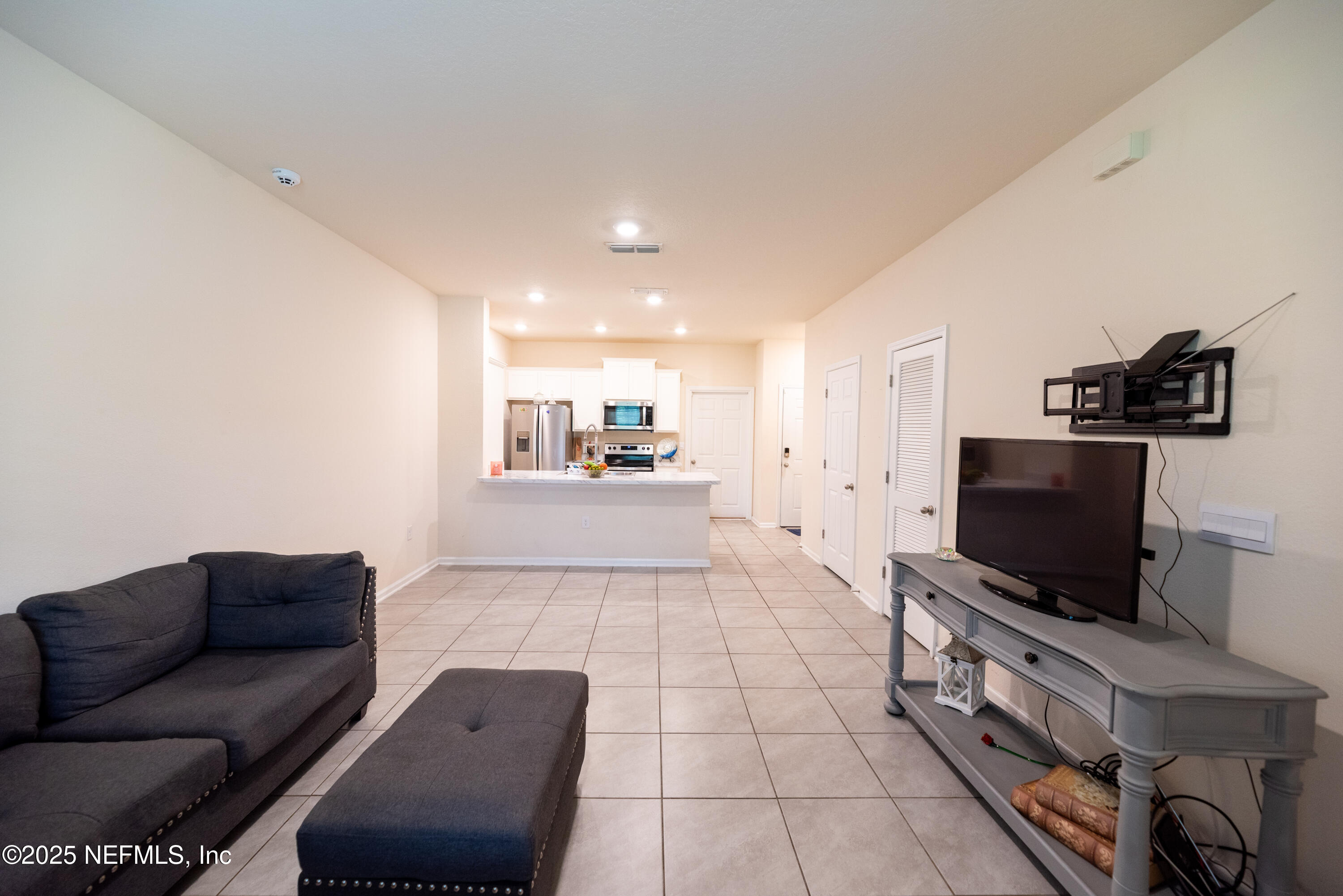 86990 Mainline Road Yulee, FL 32097 - Photo 3 of 17 a living room with furniture and a flat screen tv