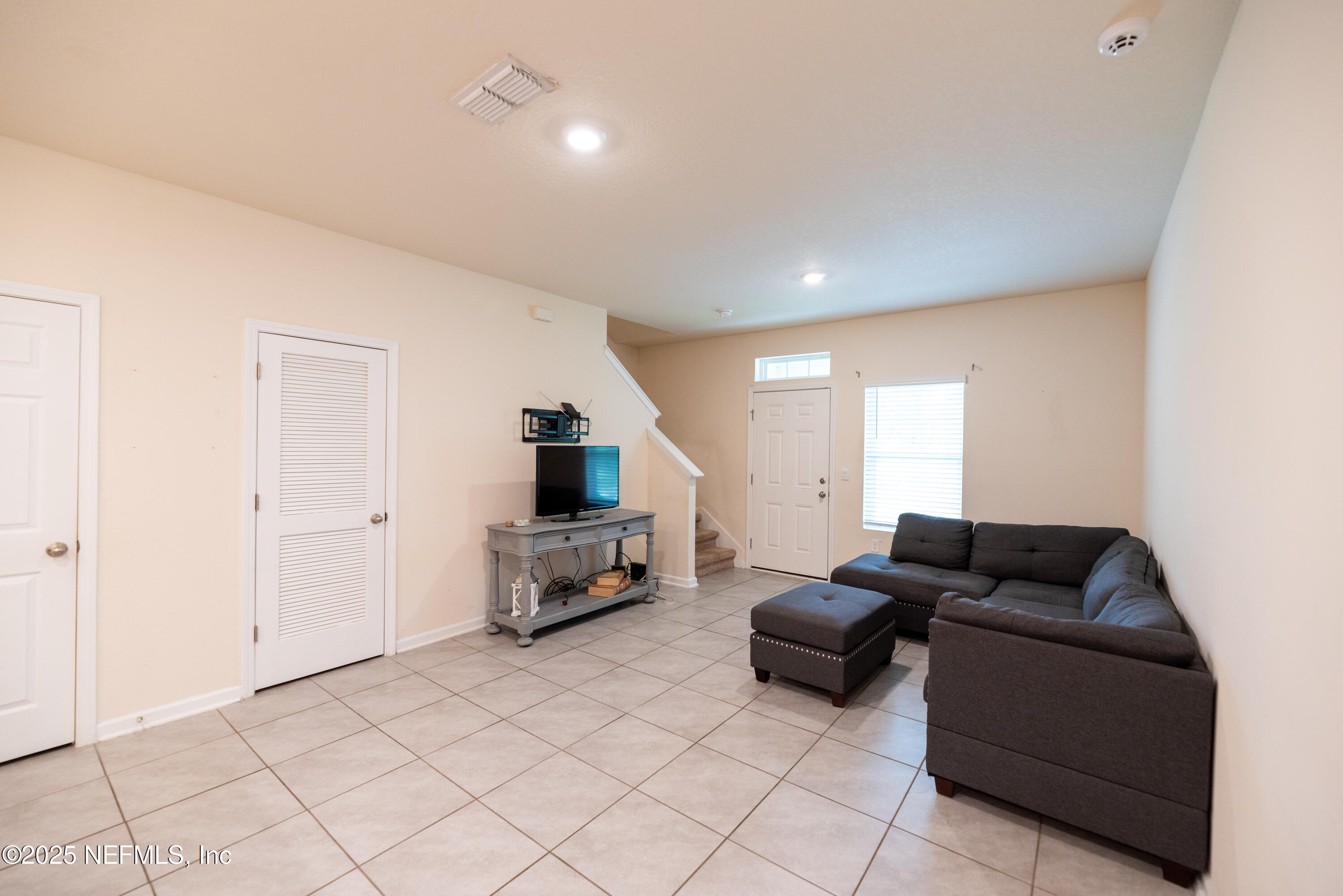 86990 Mainline Road Yulee, FL 32097 - Photo 5 of 17 a living room with furniture and a flat screen tv