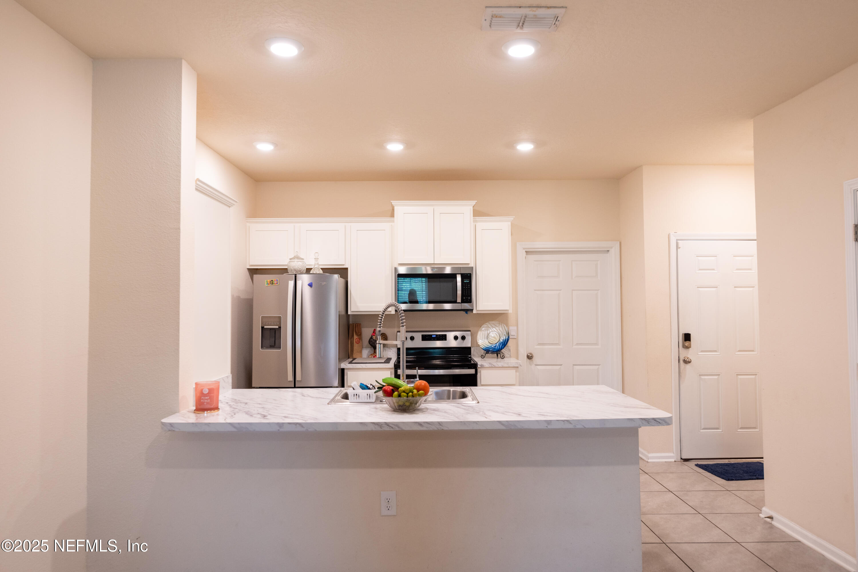 86990 Mainline Road Yulee, FL 32097 - Photo 6 of 17 a kitchen with a refrigerator and a sink