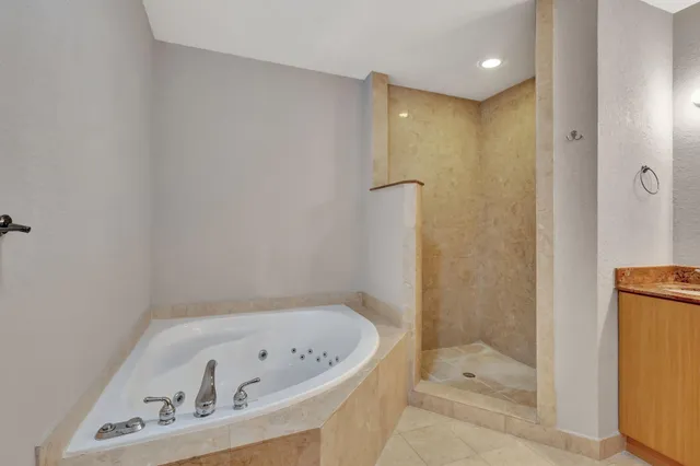 a bathroom with a bathtub and a shower