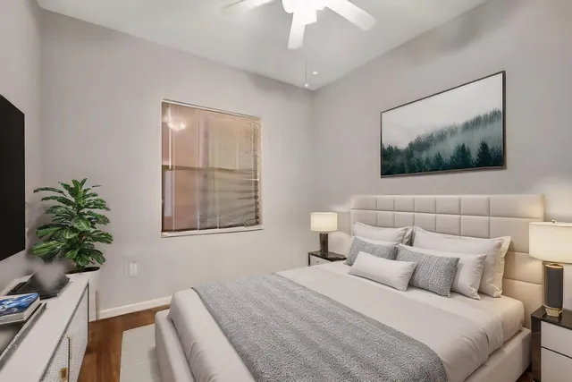 a bedroom with a bed and a flat screen tv