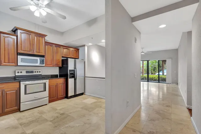a large kitchen with cabinets and stainless steel appliances